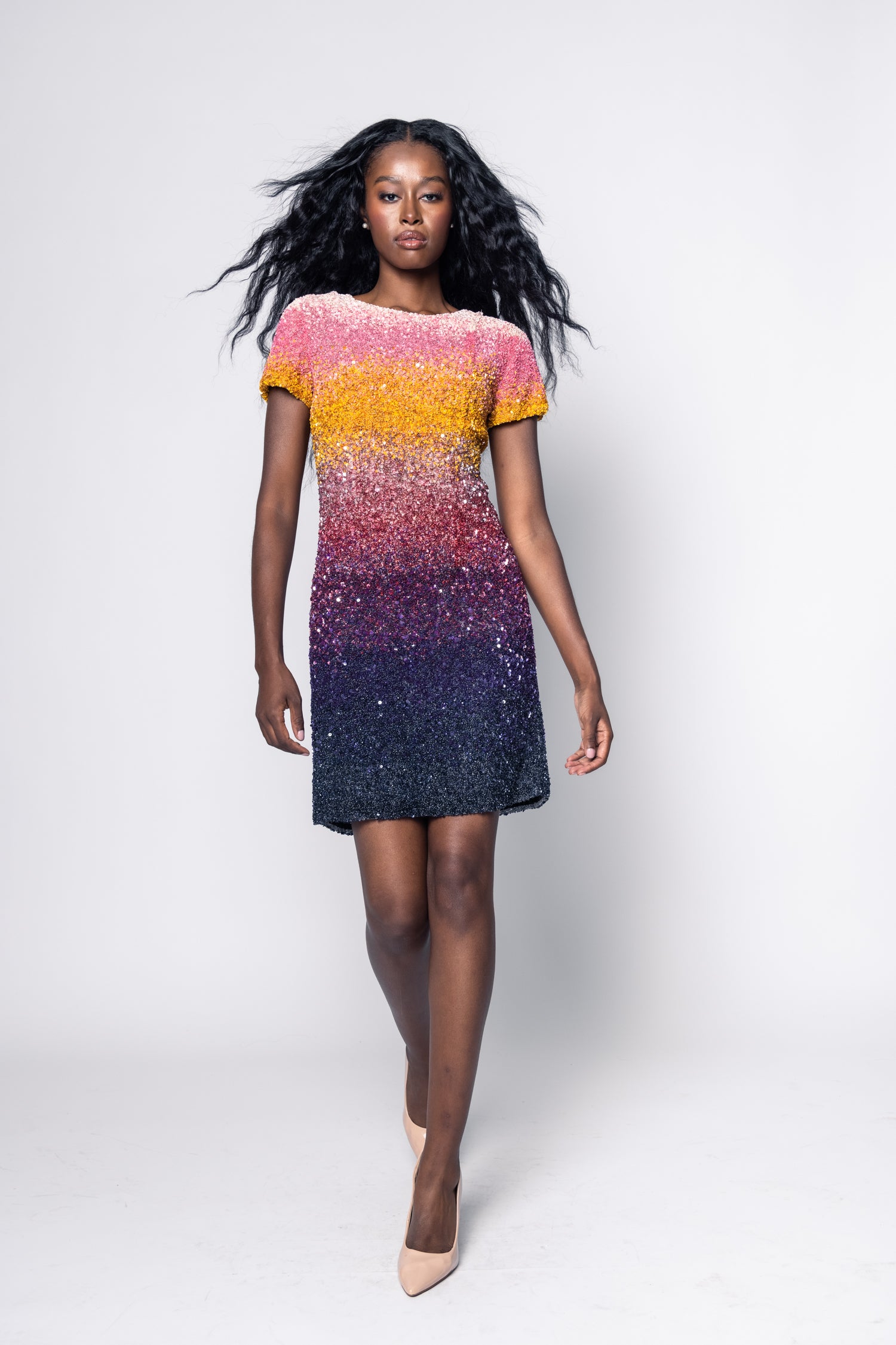 Woman wearing a colorful gradient dress on a white background