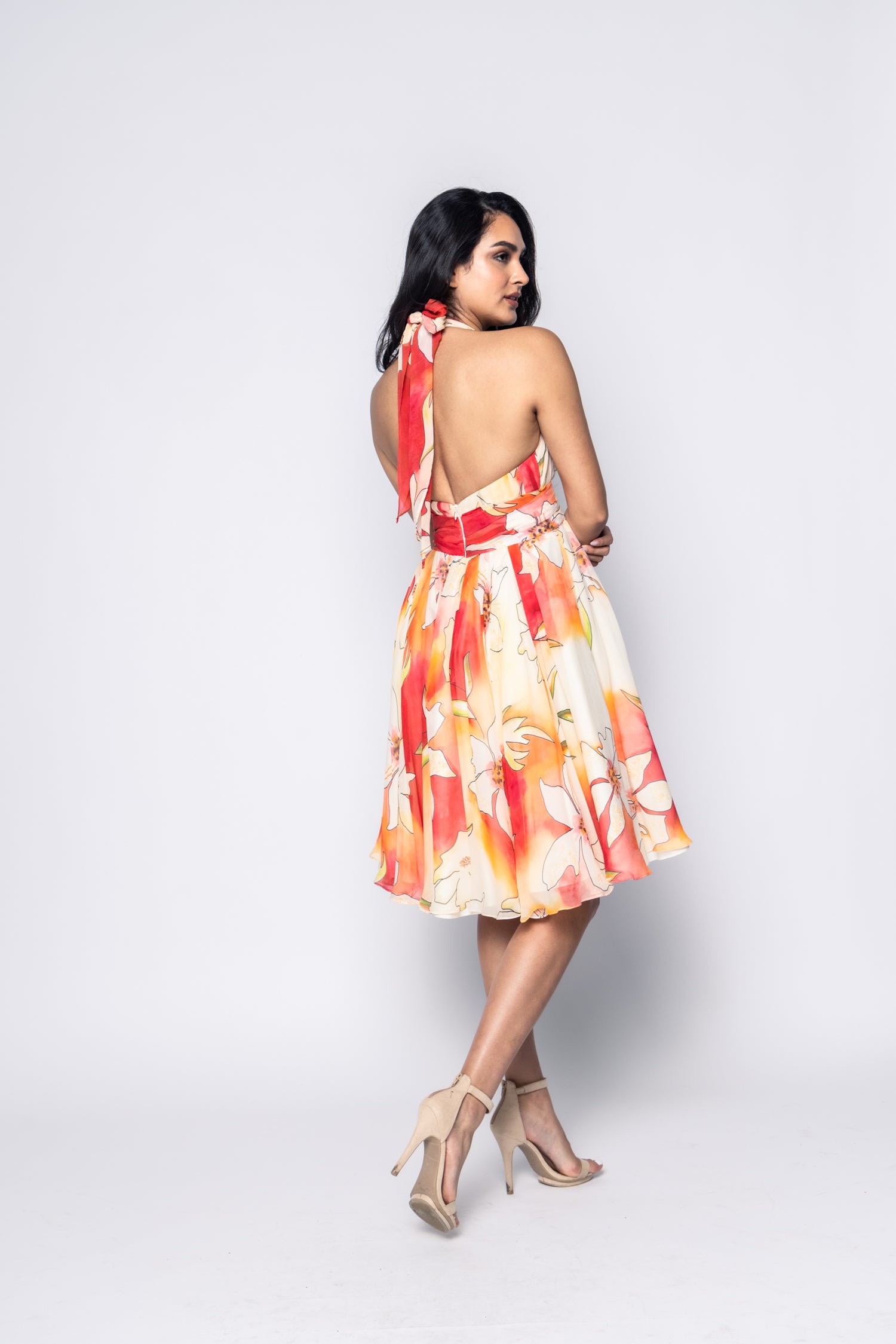 Woman wearing a colorful dress with a white background