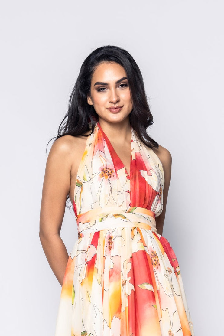 Woman wearing a floral dress against a plain background