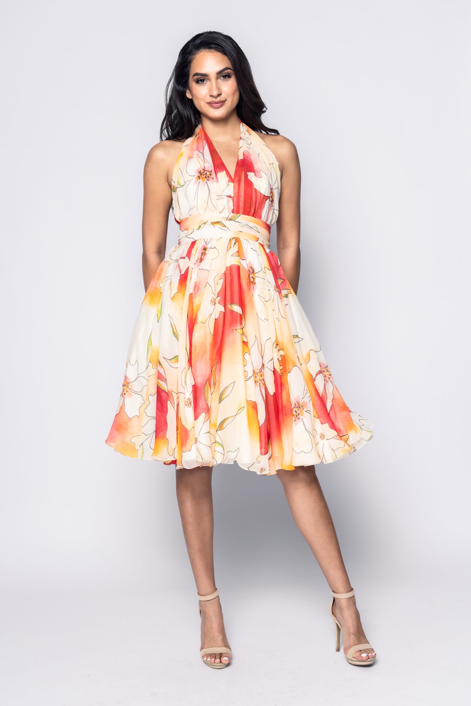 Woman wearing a colorful floral dress on a white background