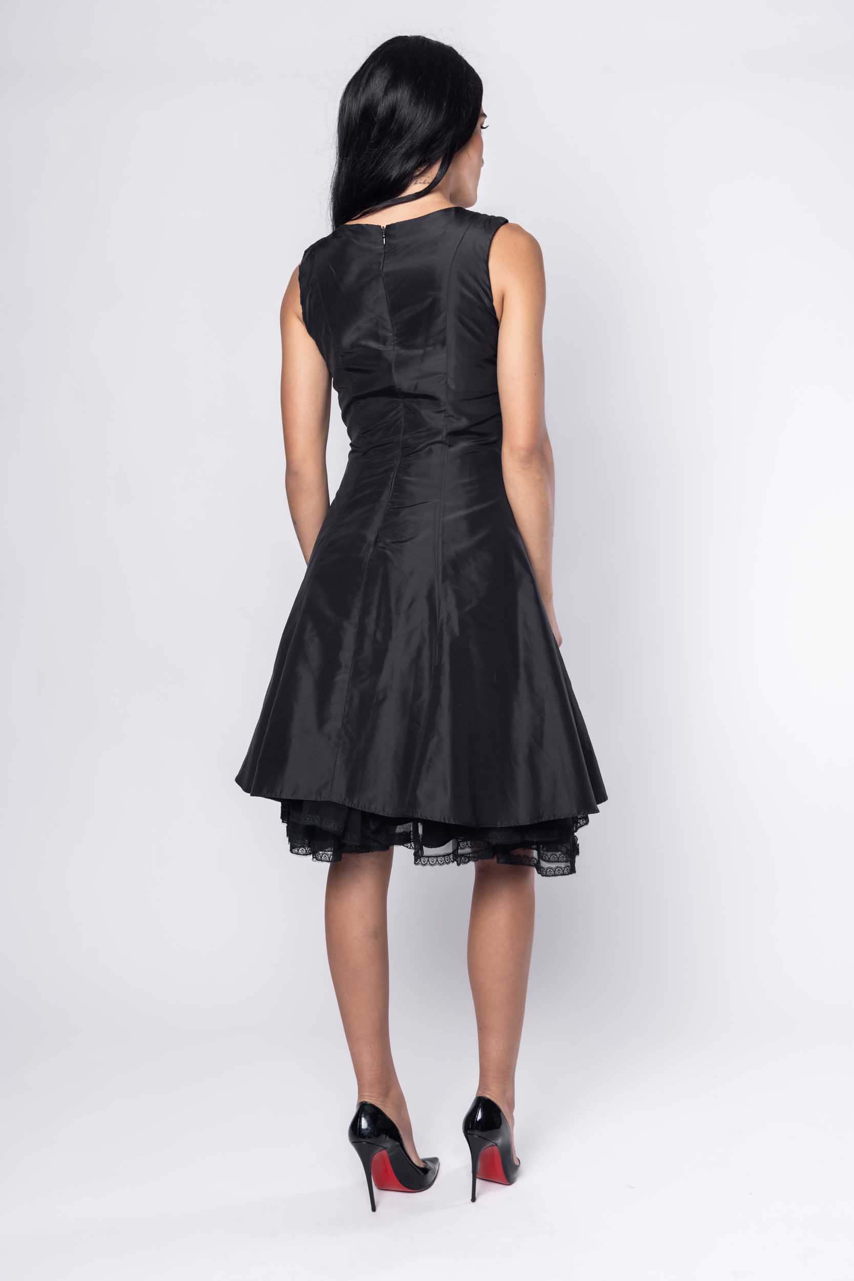 Beautiful model in black cocktail silk Sujata Gazder dress - back view