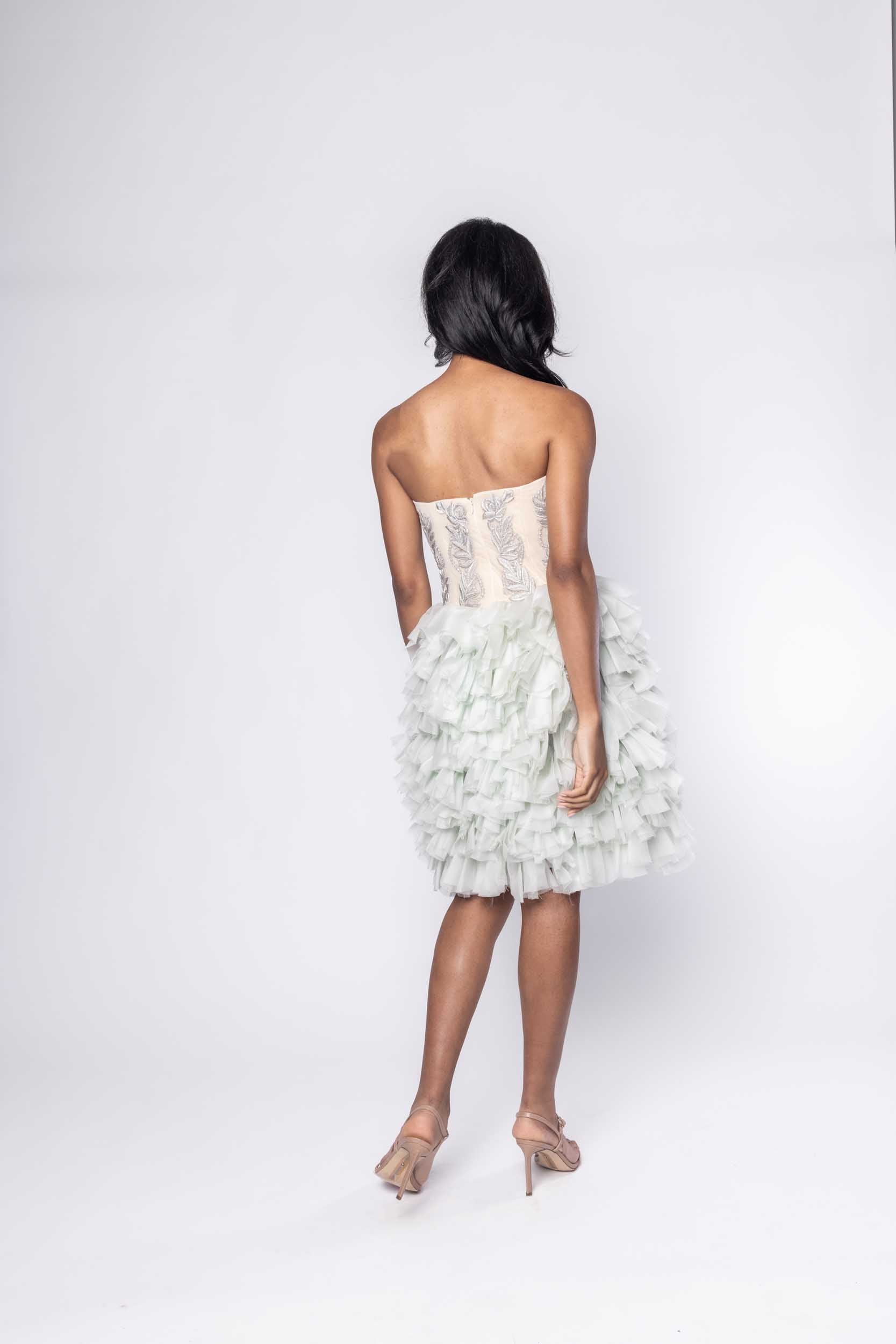 Beautiful model in blue frilly tea length Sujata Gazder cocktail dress - back view