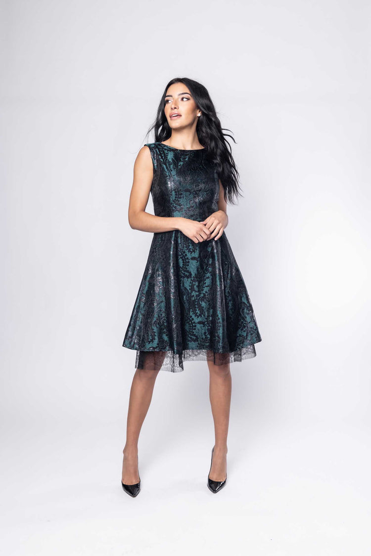 Beautiful model in a green metallic silk Sujata Gazder cocktail dress - front view movement