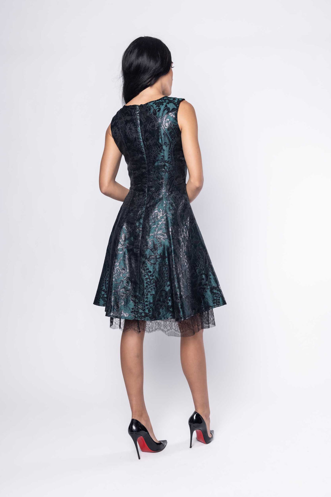 Beautiful model in a green metallic silk Sujata Gazder cocktail dress - back view