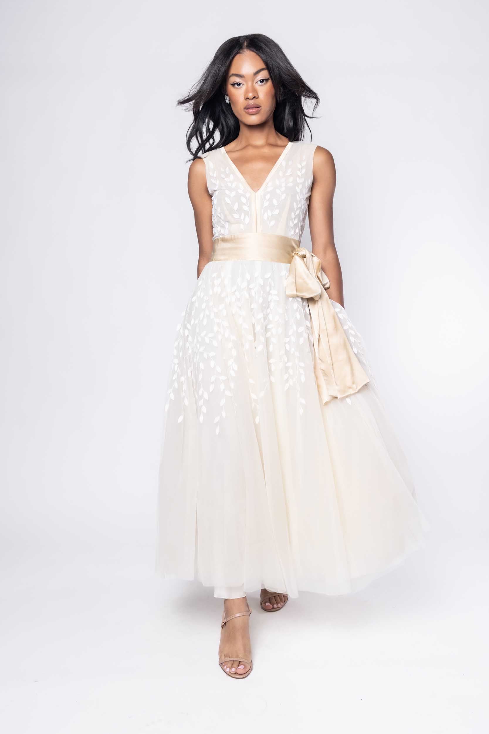 Beautiful model in ornate, nude tea-length Sujata Gazder dress - front view