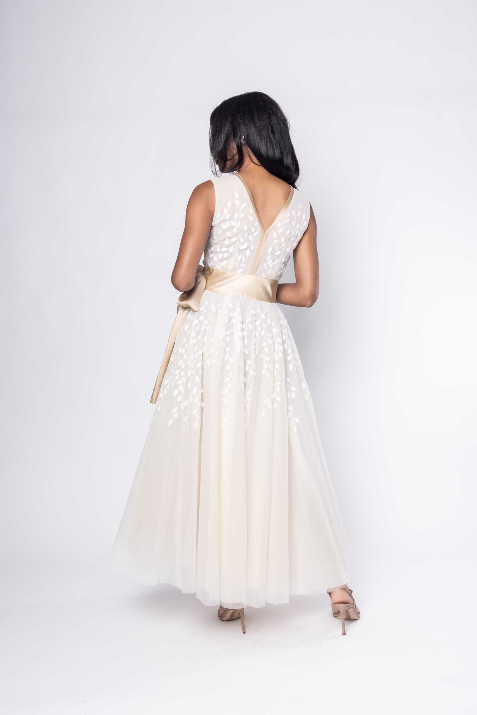 Beautiful model in ornate, nude tea-length Sujata Gazder dress - back view