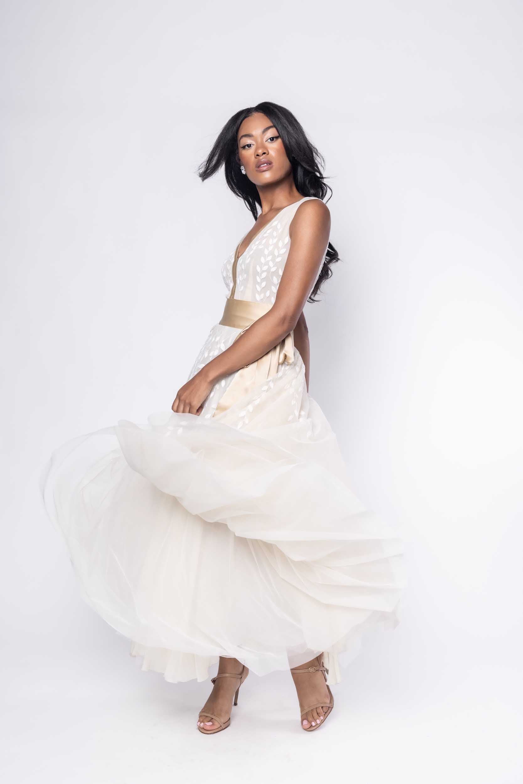 Beautiful model in ornate, nude tea-length Sujata Gazder dress - front view movement