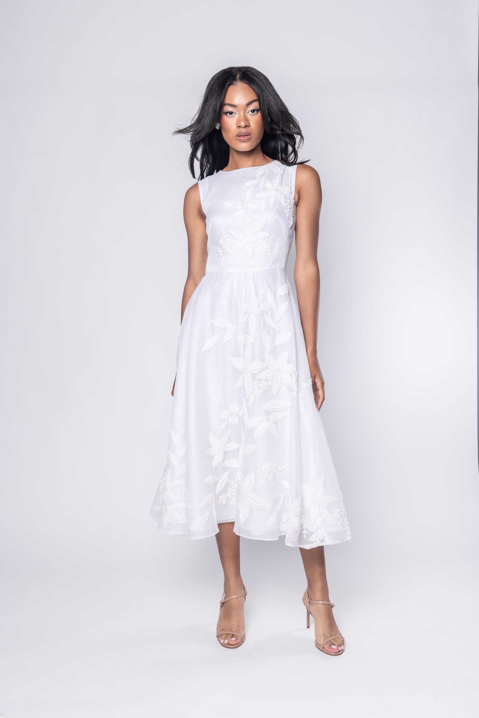 Beautiful model in an embroidered, beaded, ornate Sujata Gazder tea-length dress - front view