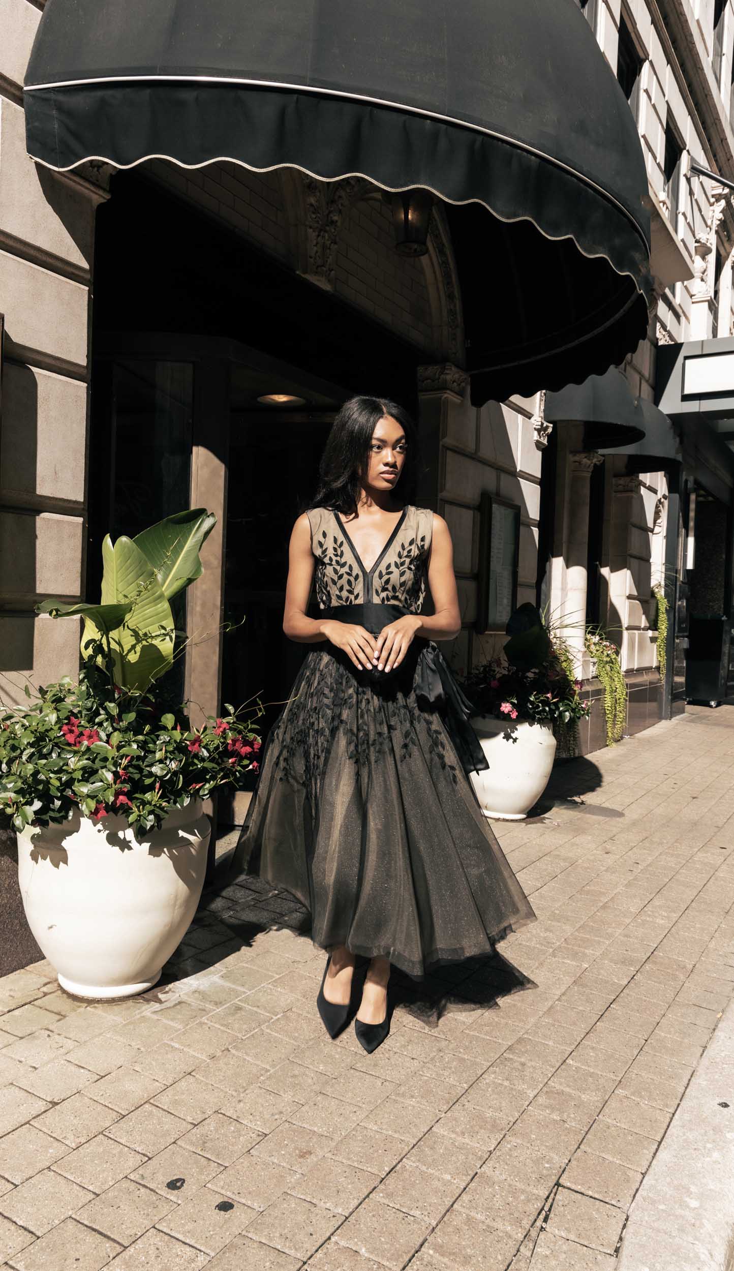 Beautiful model outside in an ornate tea-length Sujata Gazder dress