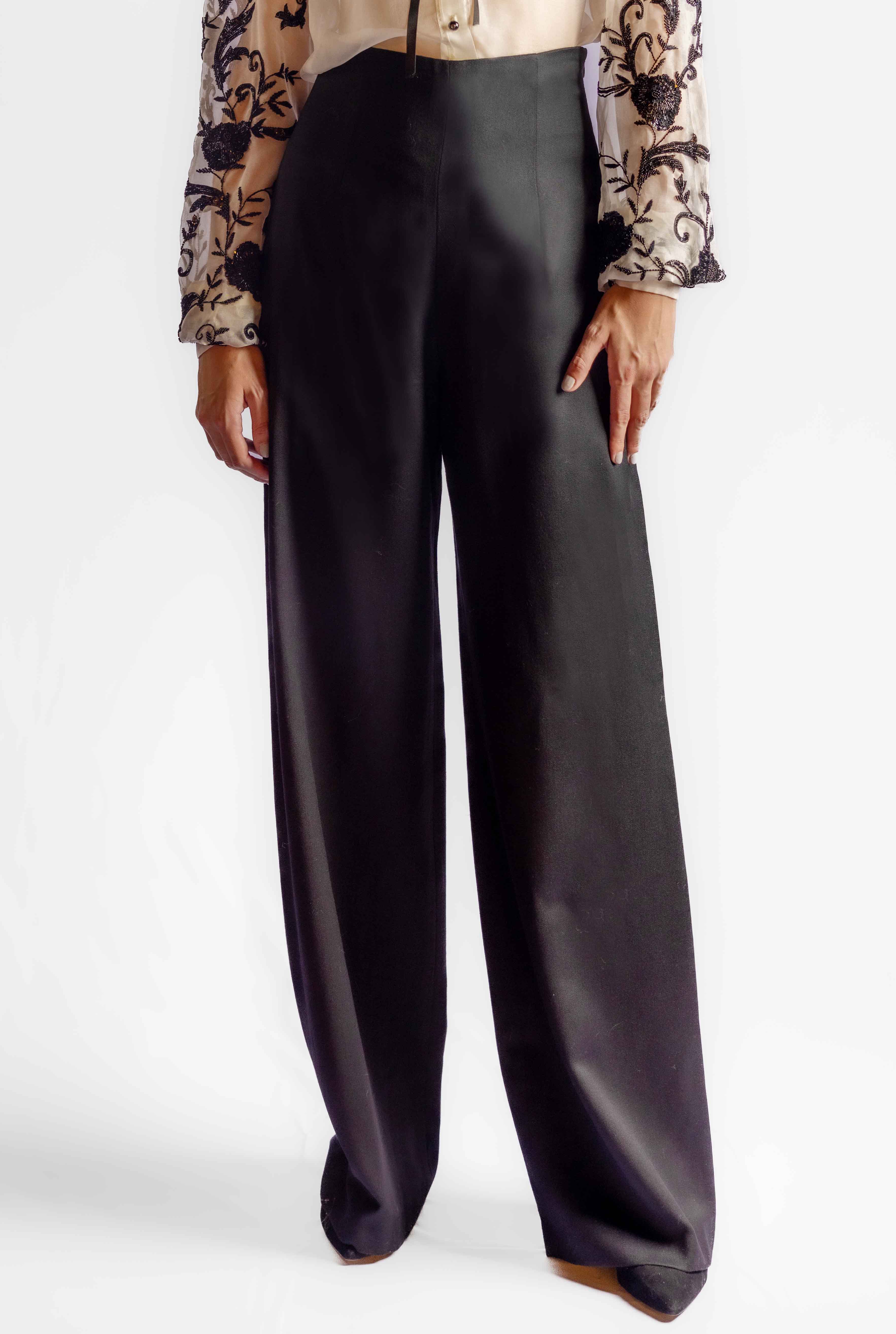Black wide-leg pants worn by a person on a white background