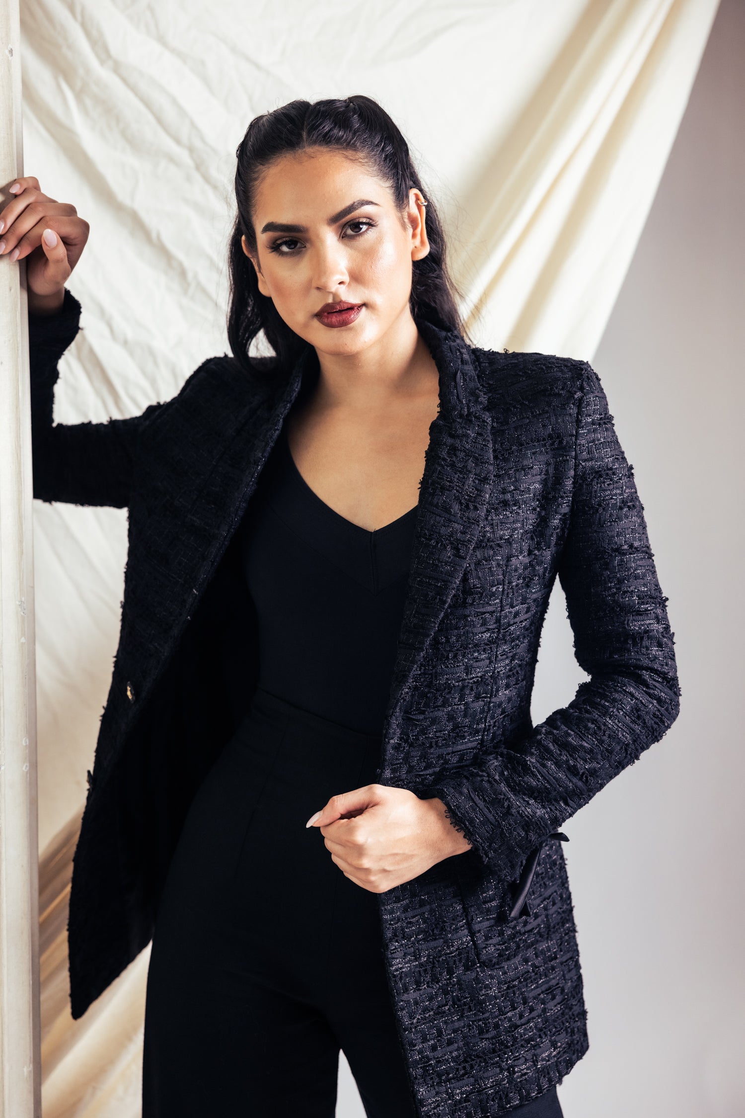 Woman in black separates in a studio setting