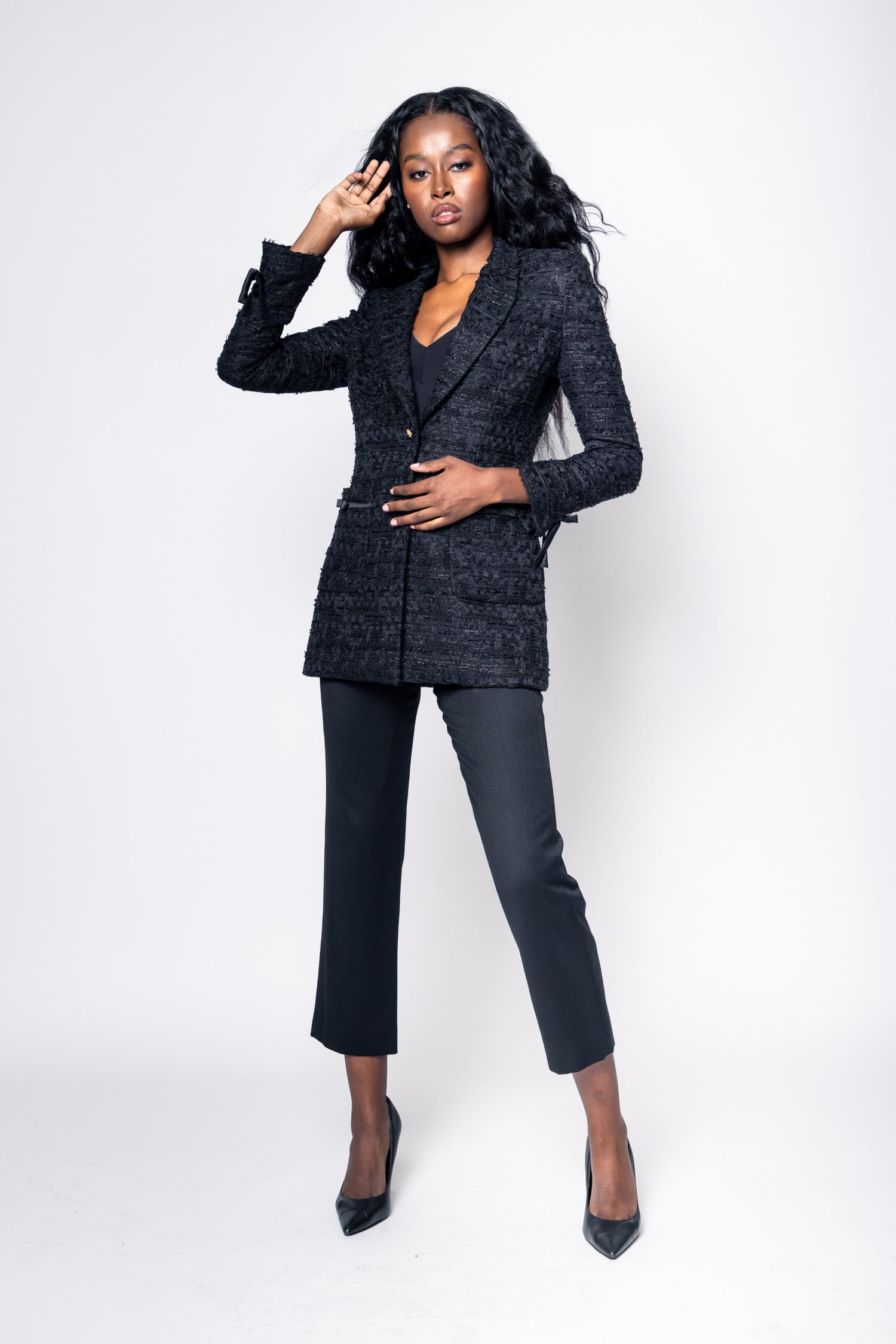 Woman wearing a black suit on a white background