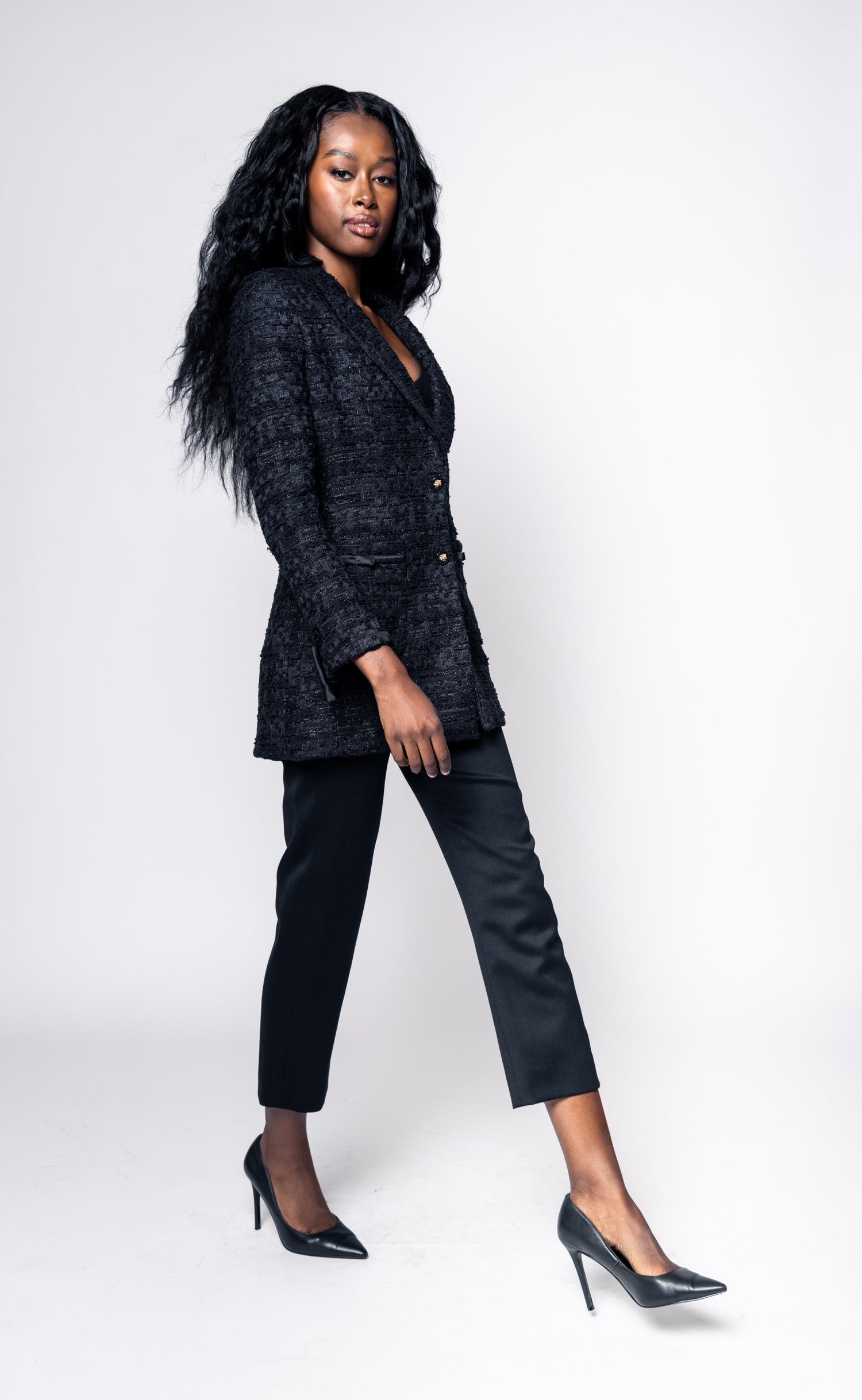 Woman wearing a black suit on a white background