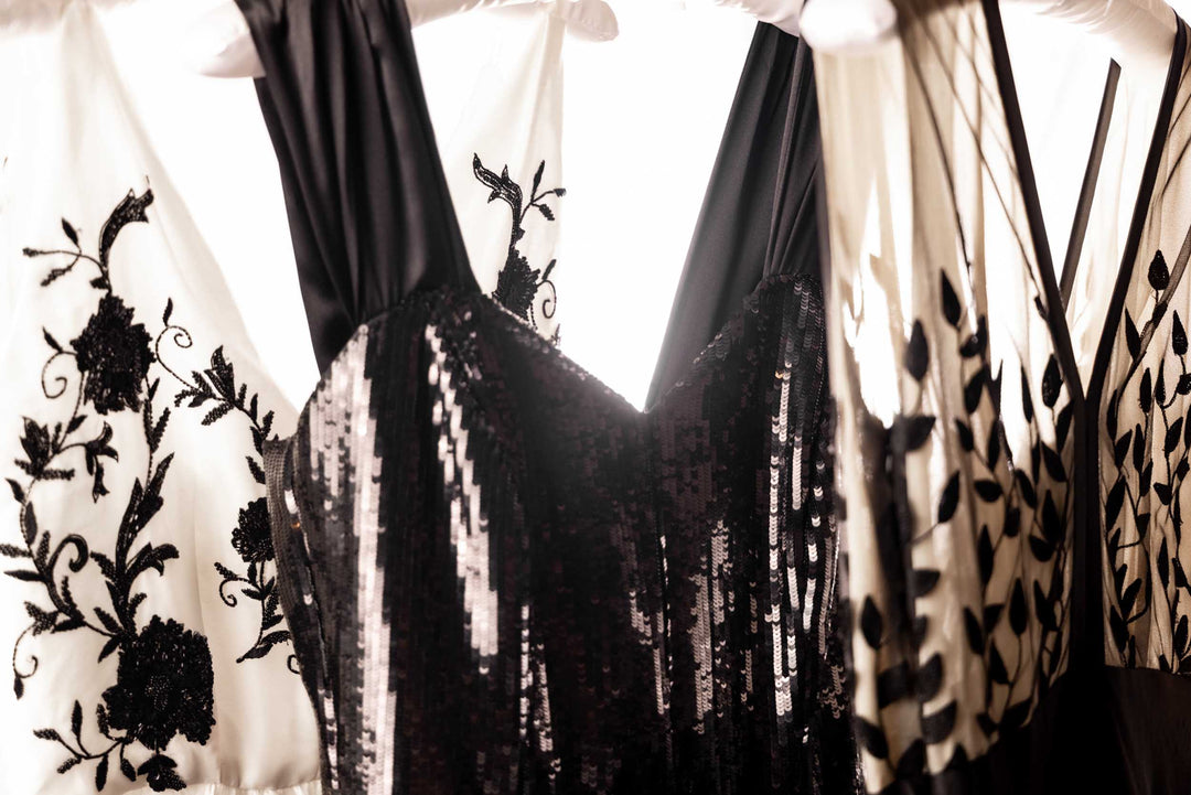 Tight shot of ornate Sujata Gazder dresses on rack 