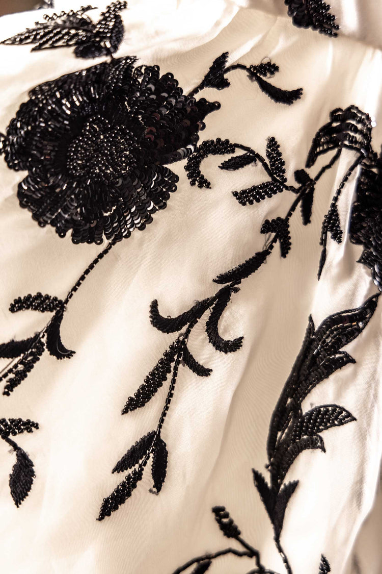 Tight shot of an ornate black and white Sujata Gazder dress 