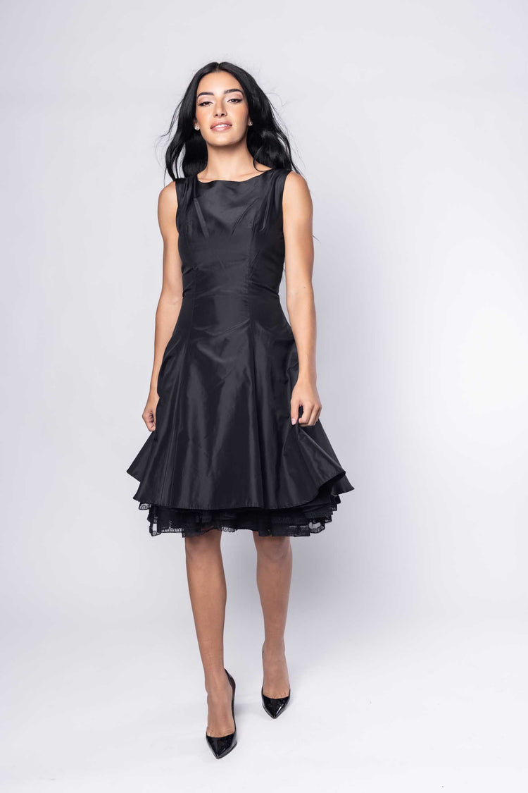 Beautiful model in black cocktail silk Sujata Gazder dress - front view movement