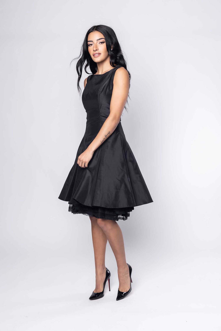 Beautiful model in black cocktail silk Sujata Gazder dress - side view