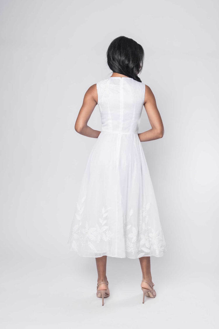 Beautiful model in an embroidered, beaded, ornate Sujata Gazder tea-length dress - back view