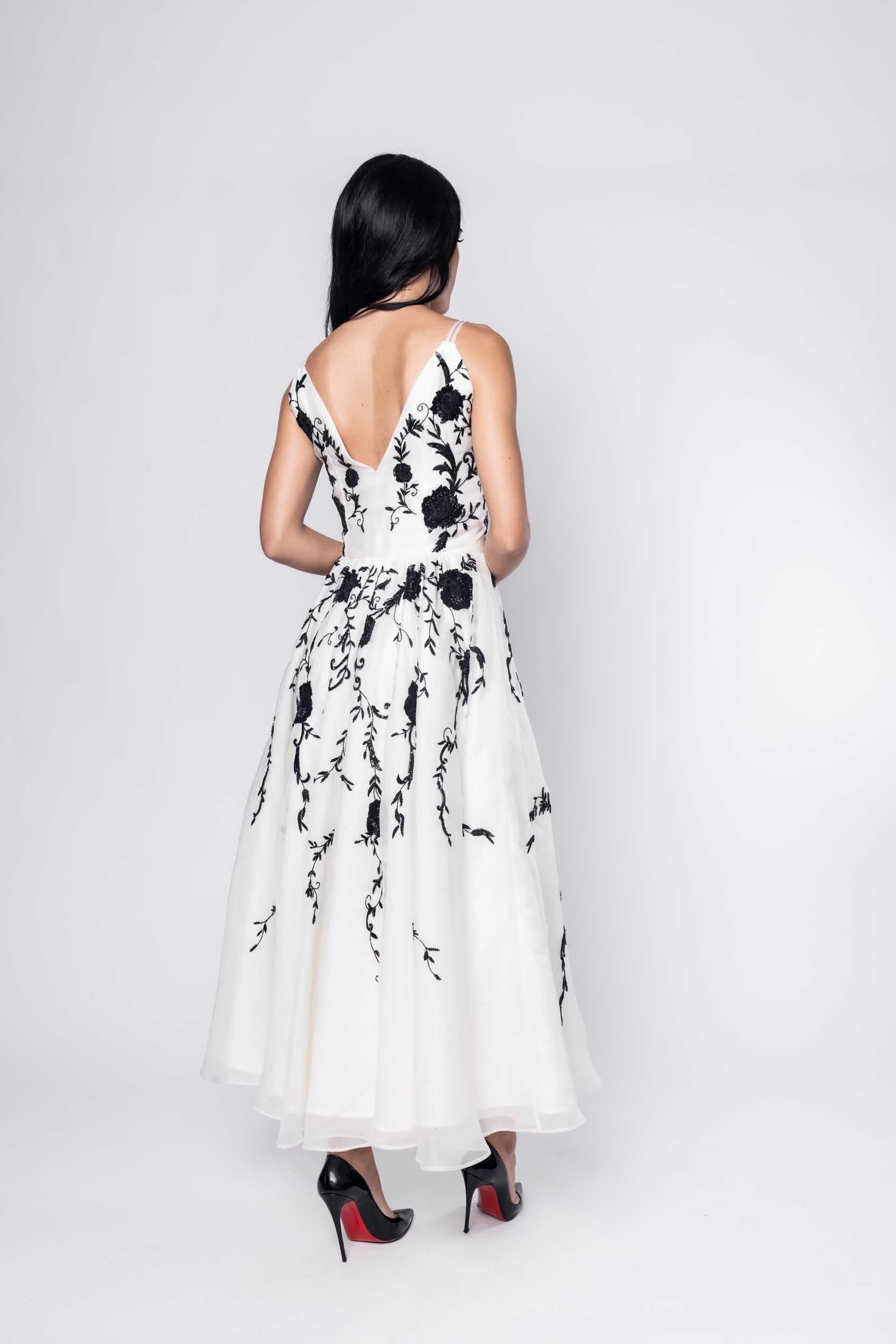 Gorgeous model in an ornate black and white Sujata Gazder dress - back view