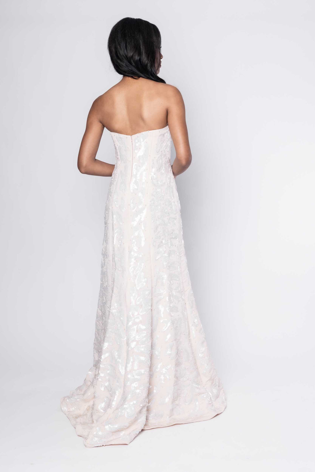 Beautiful model in floor-length white beaded Sujata Gazder gown - back view