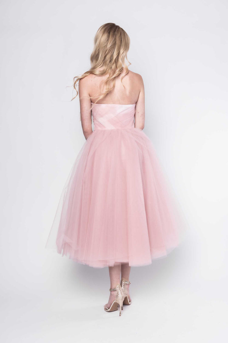 Beautiful model in a pink tulle Sujata Gazder tea-length dress - back view