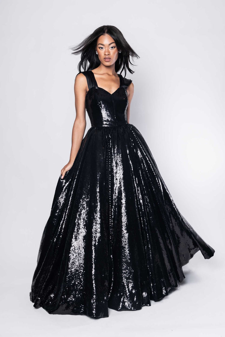 Beautiful model in an sequined, floor-length Sujata Gazder ball gown - front view movement