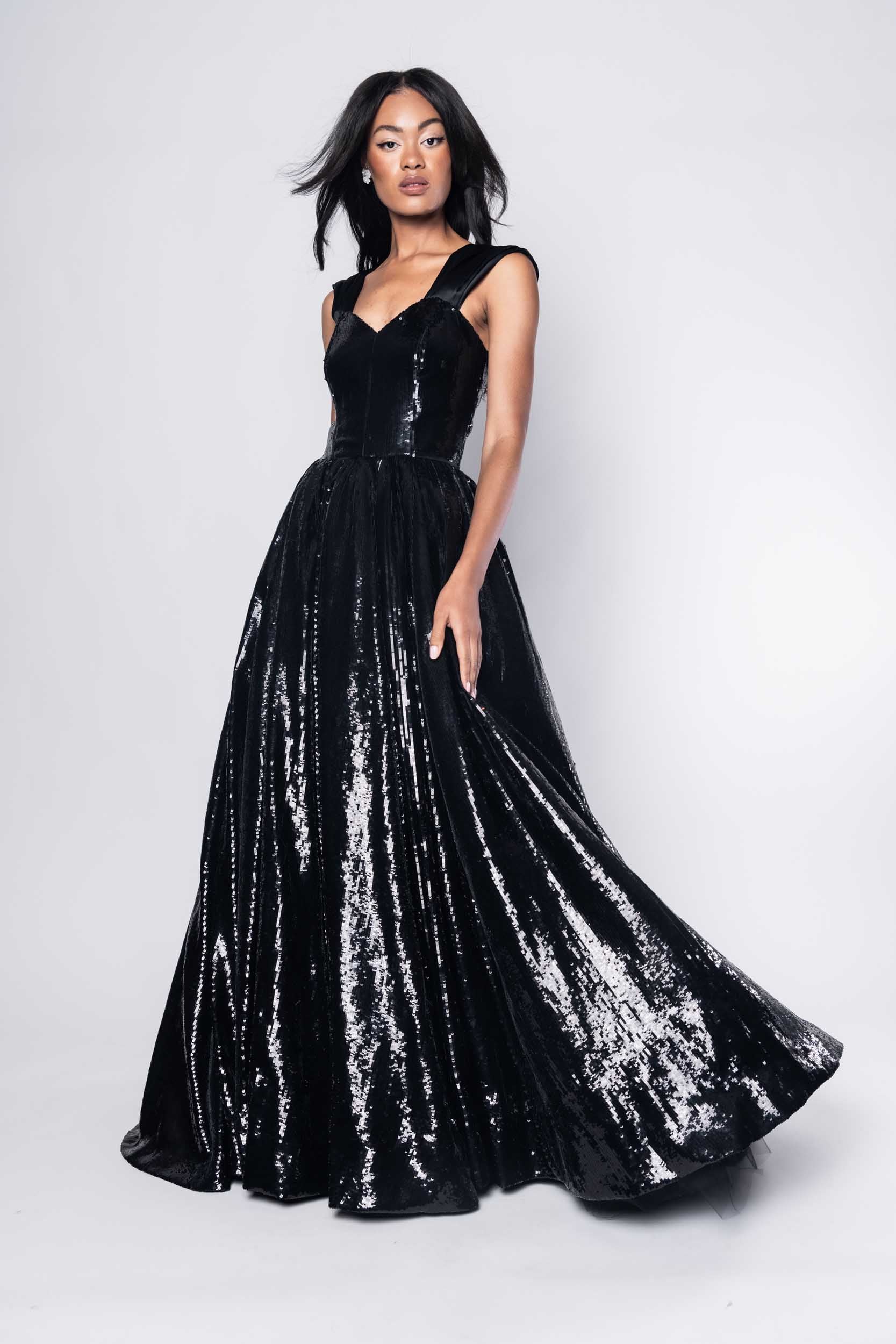 Beautiful model in an sequined, floor-length Sujata Gazder ball gown - front view movement