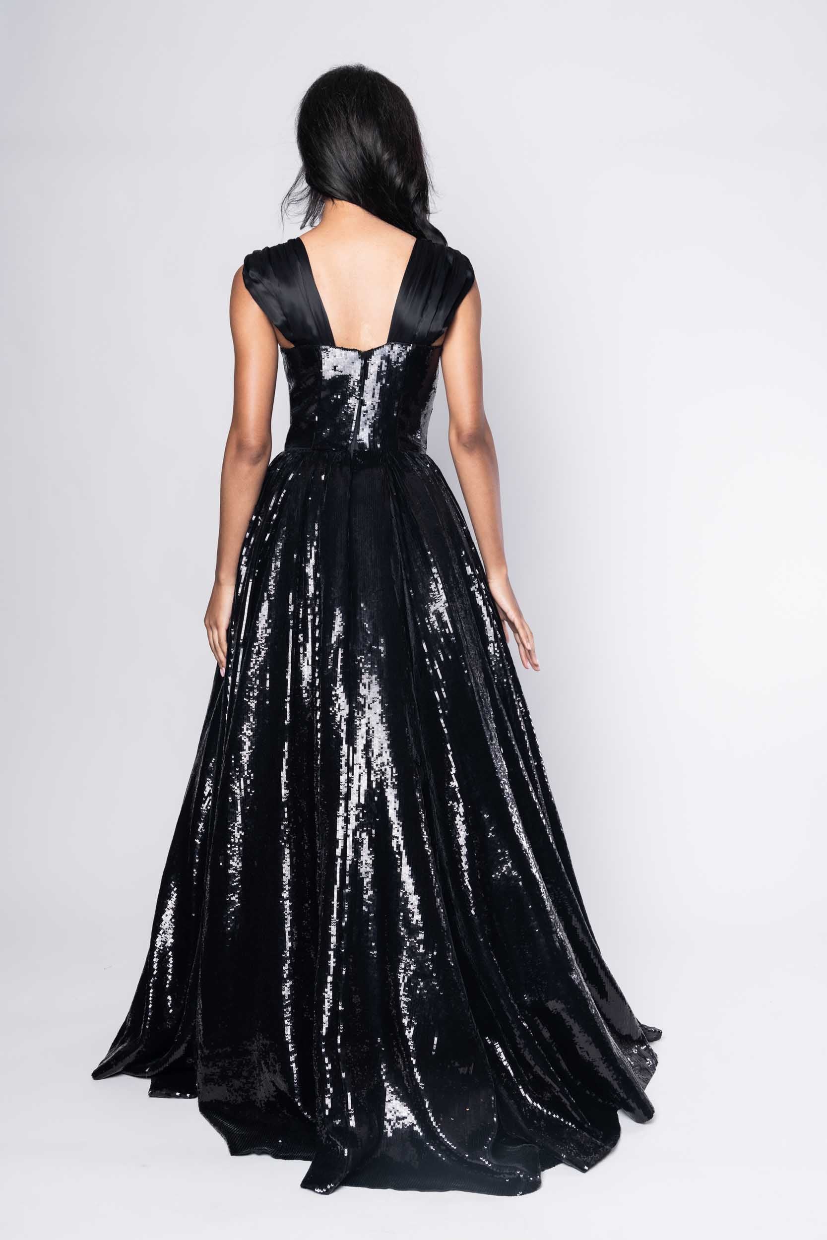 Beautiful model in an sequined, floor-length Sujata Gazder ball gown - back view