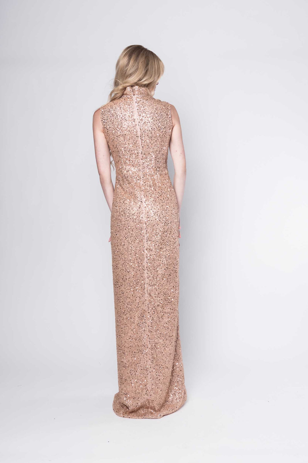 Beautiful model in a sequined rose gold floor-length Sujata Gazder gown - back view