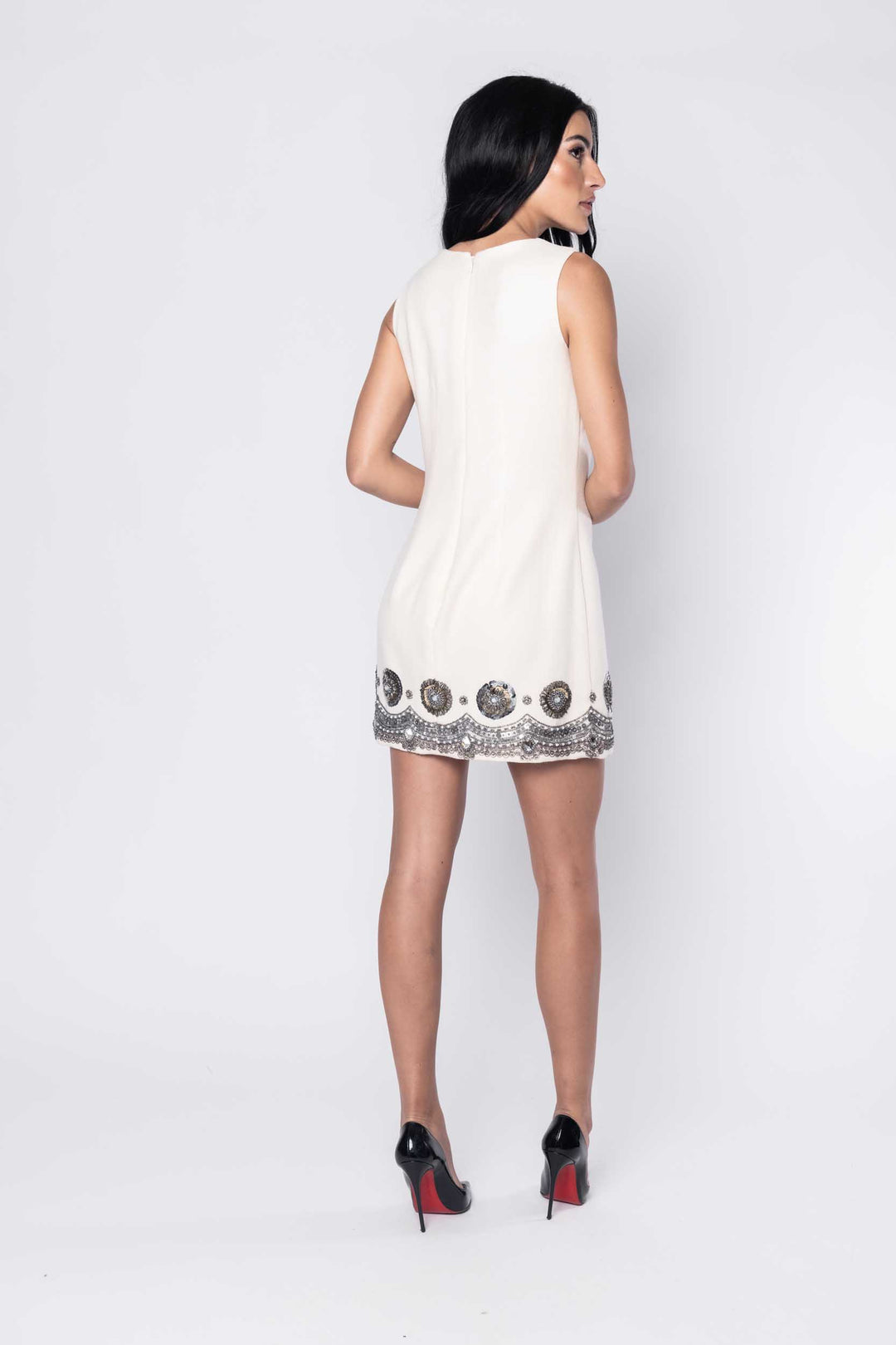 Beautiful model in white Sujata Gazder cocktail dress with decorative hem - back view