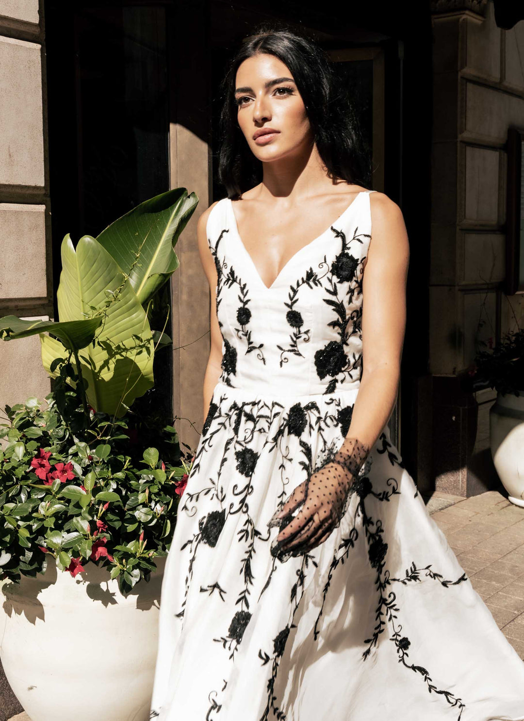 A ornate black and white Sujata Gazder dress on a model in the street
