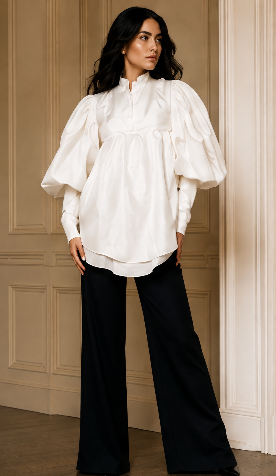 Model wearing a white blouse and black trousers